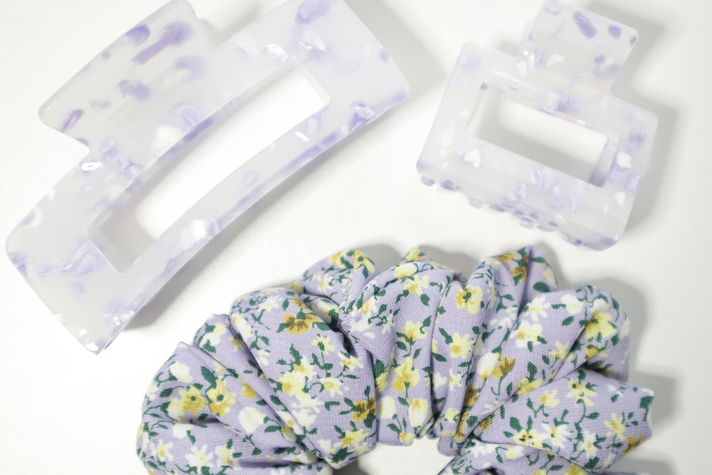 Floral scrunchie on a white background. 4" and 2" claw clips on top. 