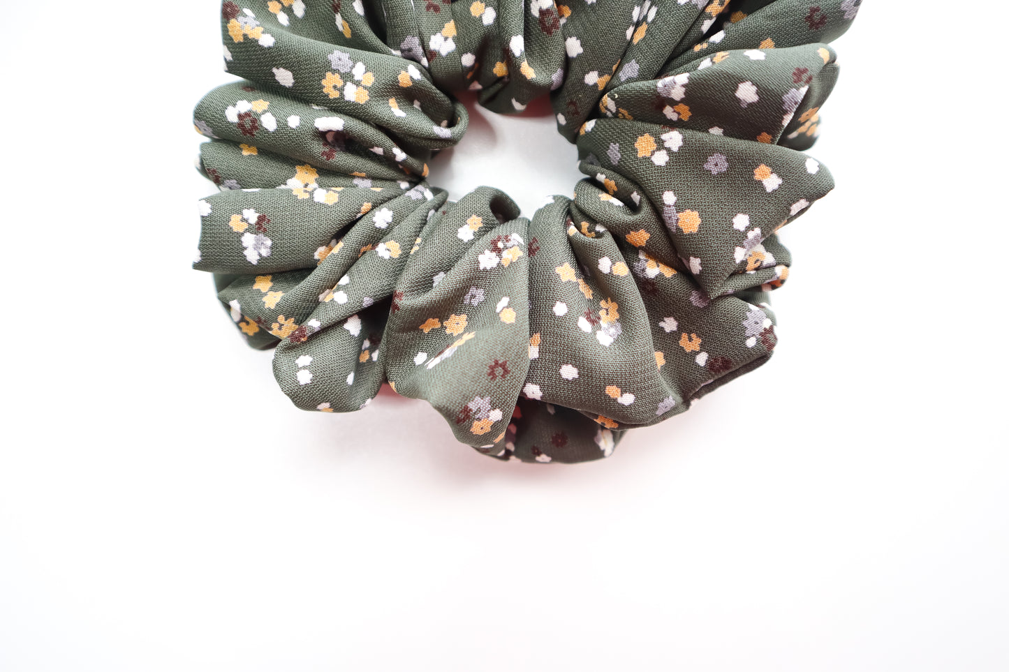 Green floral scrunchie on a white background