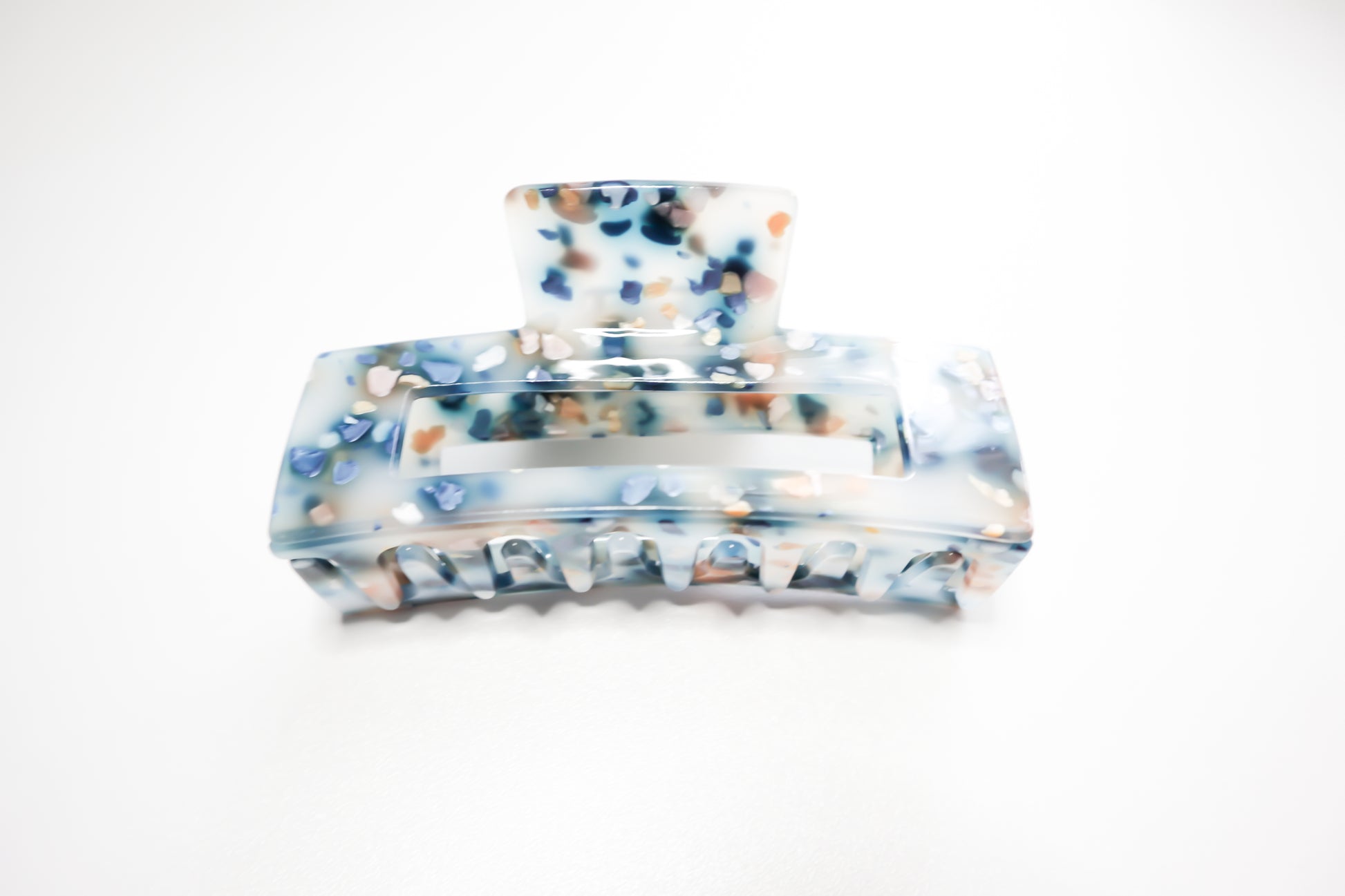 Blue and brown marble spec hair claw clips on a white background