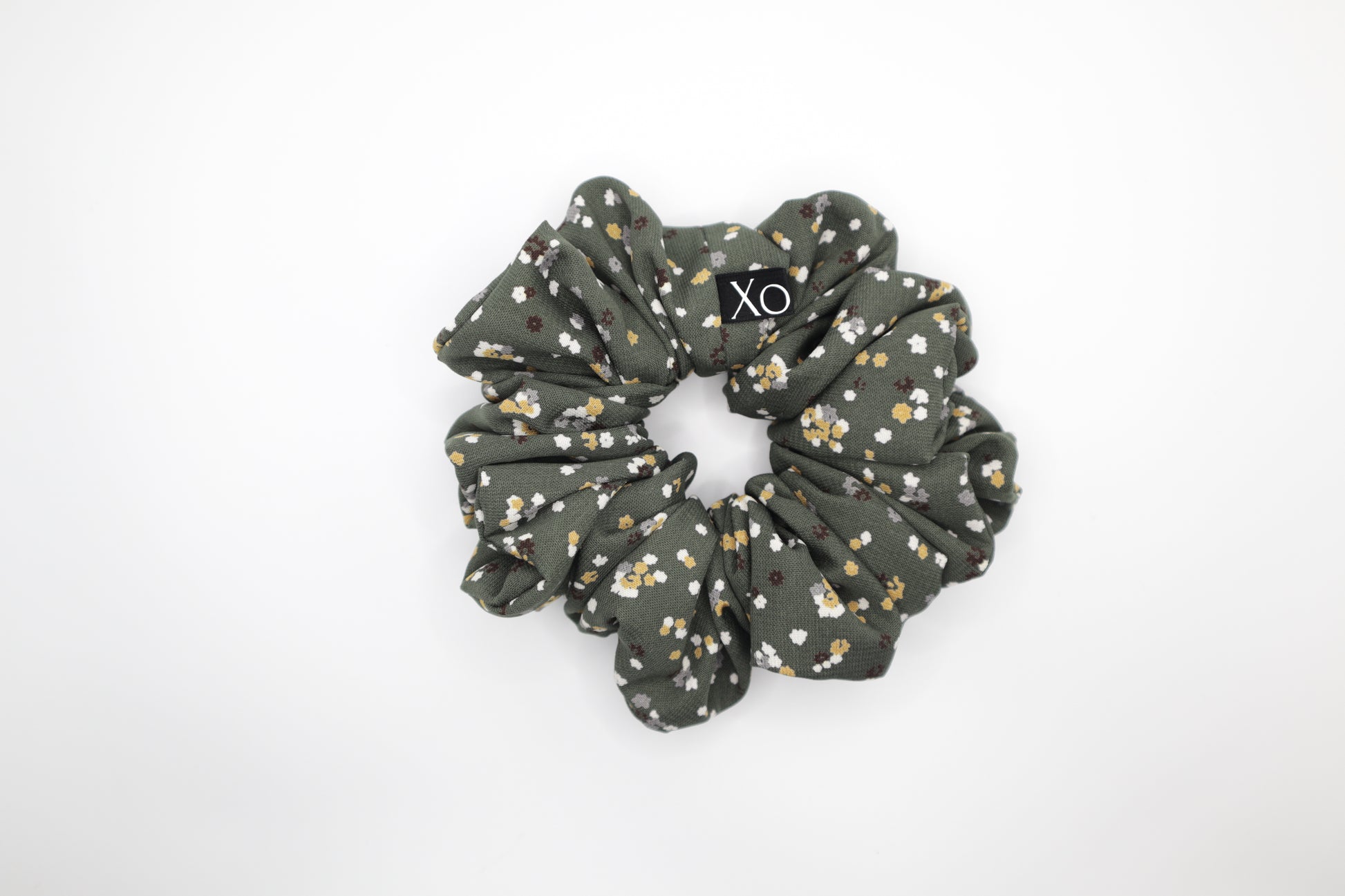 Green floral scrunchie on a white background