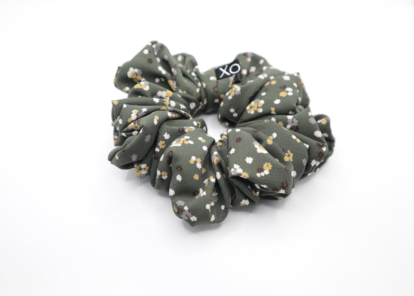 Green floral scrunchie with 'XO' on a white background
