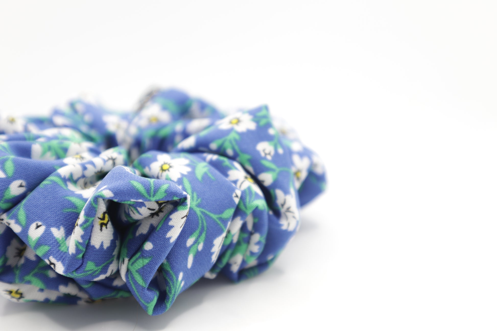 Blue floral scrunchie on a white background. 