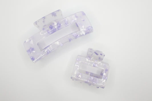 Set of two clear hair clips with purple accents on a white background. Top Claw clip is 4" and bottom claw clip is 2"