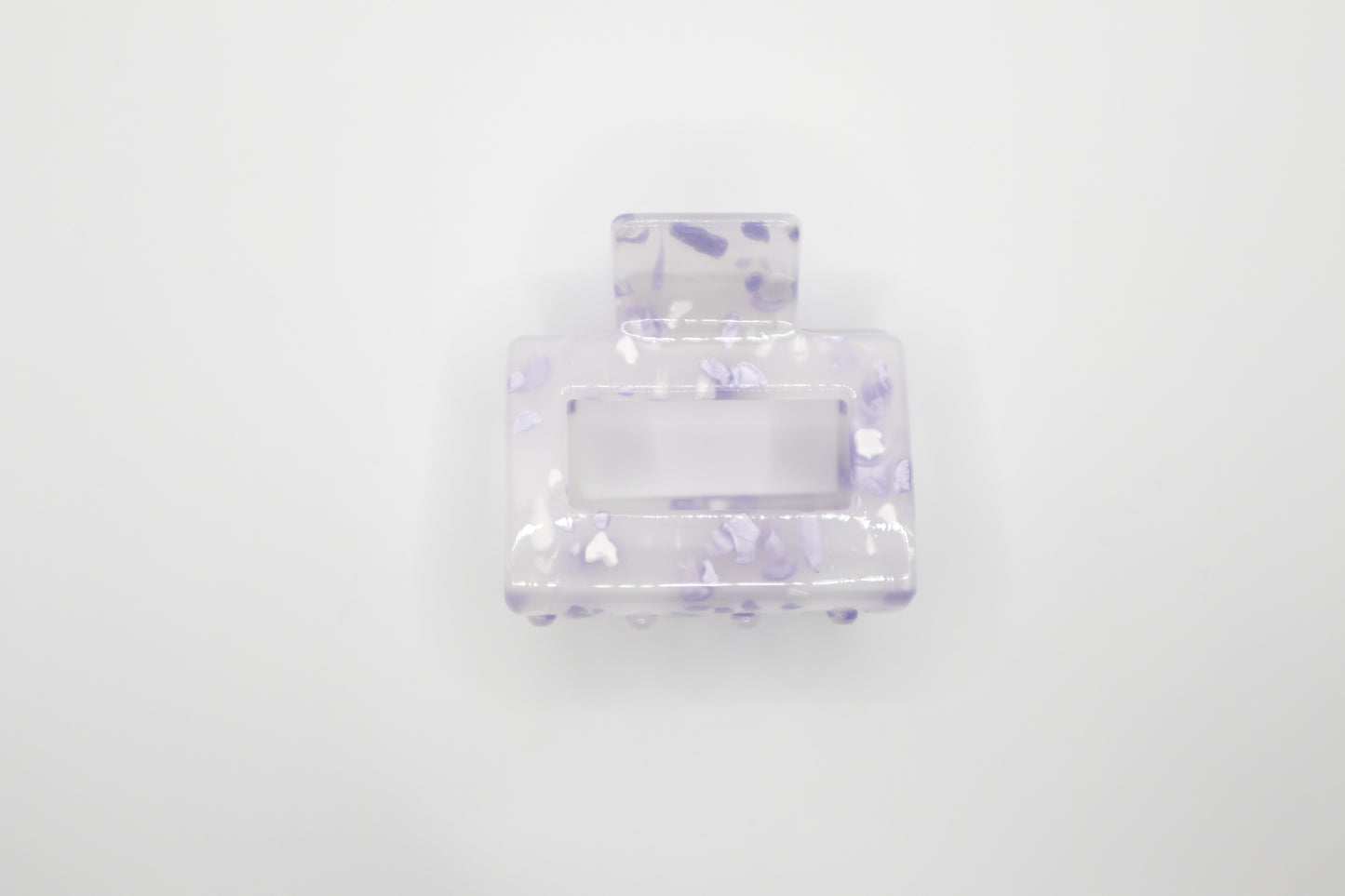 Clear 2" hair claw clip with purple speckles on a white background