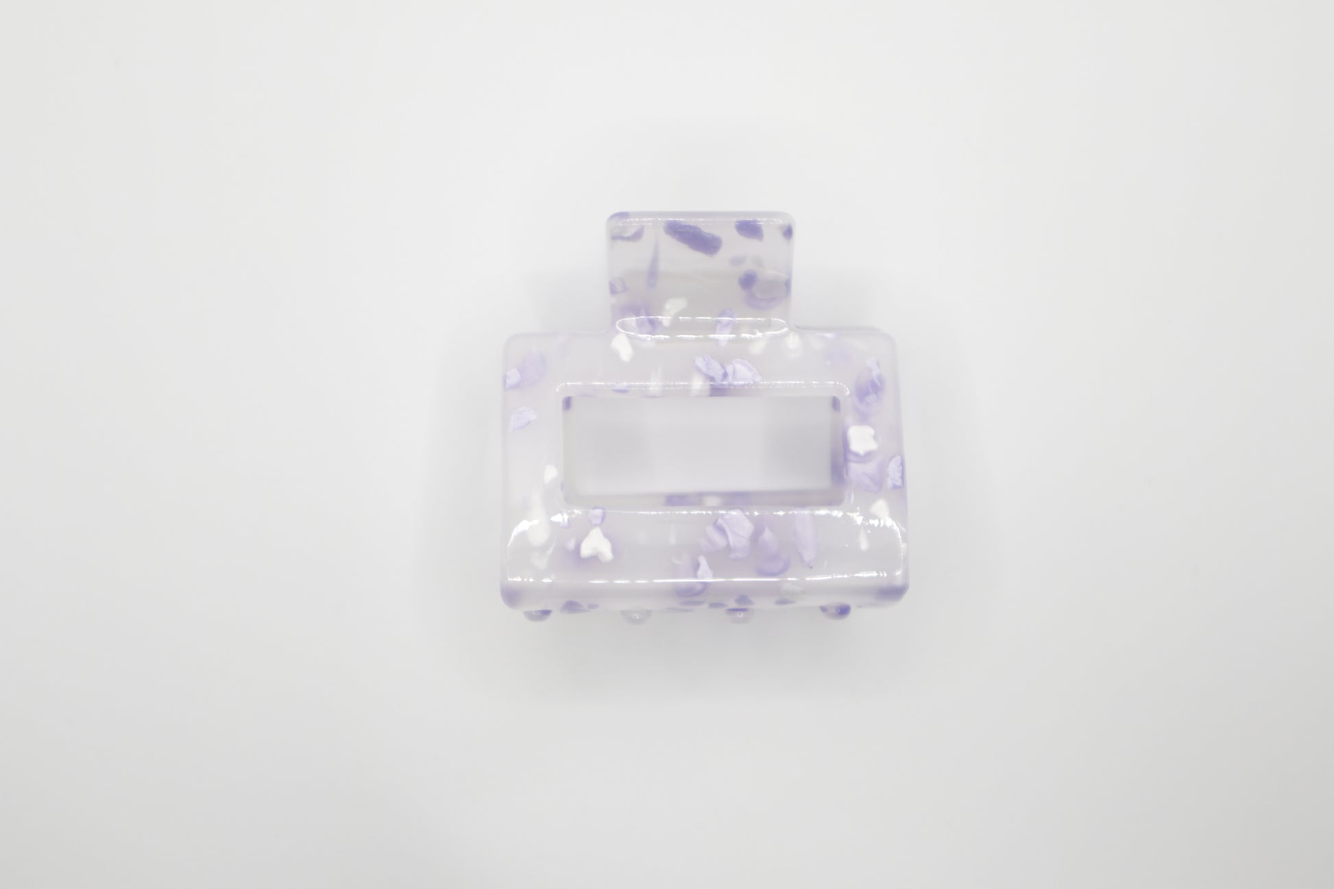 Clear 2" hair claw clip with purple speckles on a white background