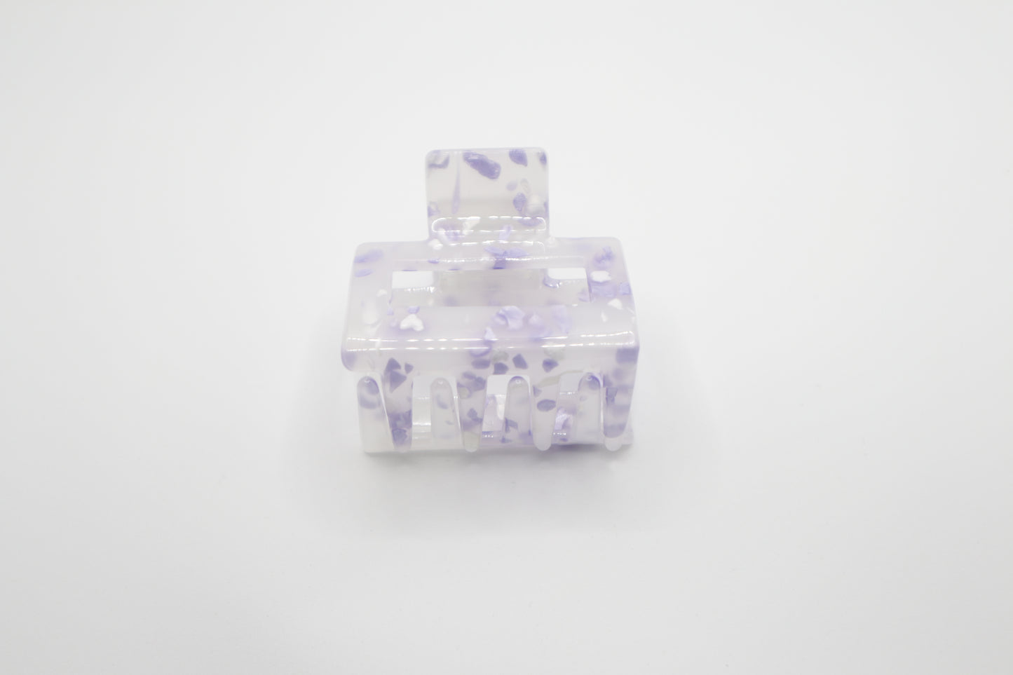 Clear 2" hair claw clip with purple speckles on a white background