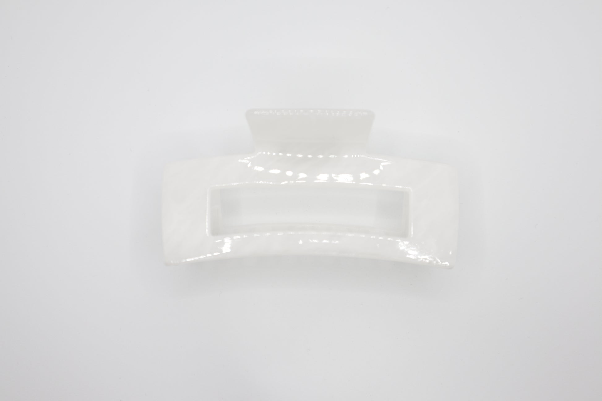 Rectangular white Hair claw clip on a light gray background